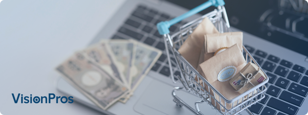 Top down perspective on a mini shopping cart and money on a laptop.