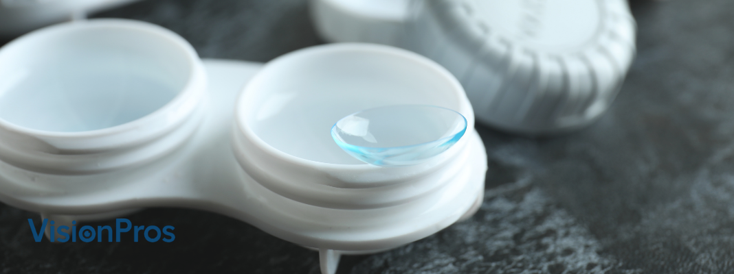 Contact lens case with a soft contact lens resting in the right cup, VisionPros logo in the corner
